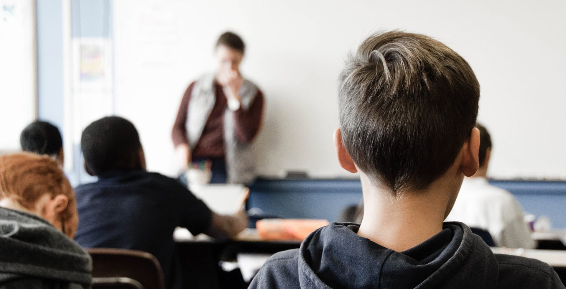 Elever och en lärare i ett klassrum.